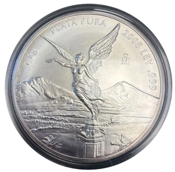 Abbildung der 1 Kilo Silbermünze „Libertad“ aus Mexiko, Jahrgang 2008. Auf der Vorderseite ist die geflügelte Siegesgöttin „Victoria“ vor den Vulkanen Popocatépetl und Iztaccíhuatl zu sehen. Die Münze besteht aus 999 Feinsilber und hat einen Durchmesser v Abbildung der 1 Kilo Silbermünze „Libertad“ aus Mexiko, Jahrgang 2008. Auf der Vorderseite ist die geflügelte Siegesgöttin „Victoria“ vor den Vulkanen Popocatépetl und Iztaccíhuatl zu sehen. Die Münze besteht aus 999 Feinsilber und hat einen Durchmesser v